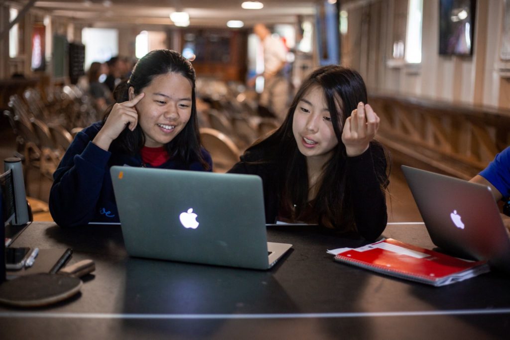 two national youth science camp delegates sit at a computer during a directed study